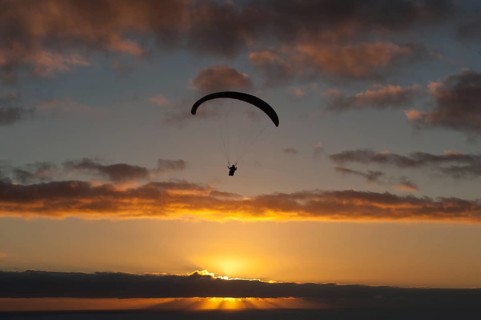 Paragliding over the Atlantic near Puerto Naos during sunset