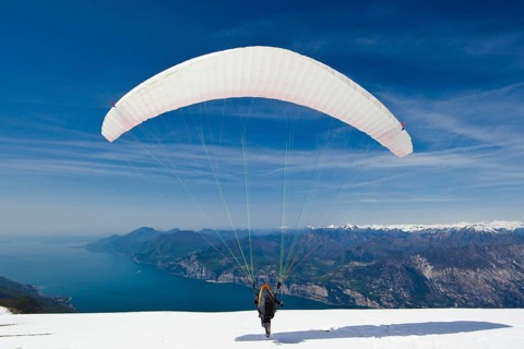 Launch of a paraglider on Monte Baldo above Lake Garda
