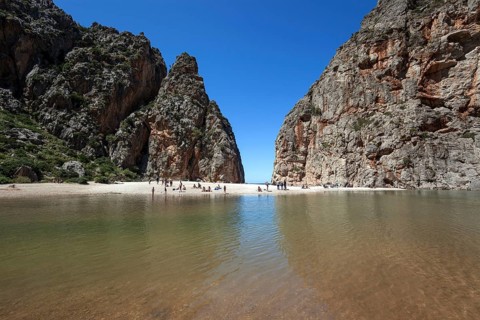 People on the beach in the gorge Torrent de Pareis