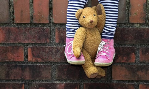 Teddy clamped between legs