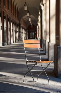 Single folding chair under arcades