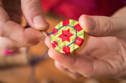 Button maker stitching and wrapping green