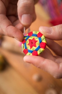 Button maker stitching and wrapping green