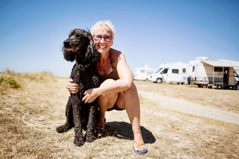 Woman embraces her dog