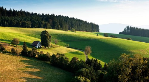 Lonely farmhouse in hilly landscape