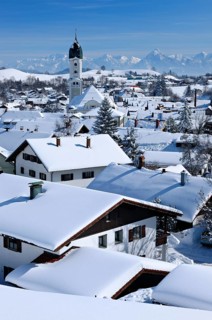 View of snow-covered roofs in winter with St. Andreas church