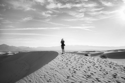 Young man photographing sand dunes