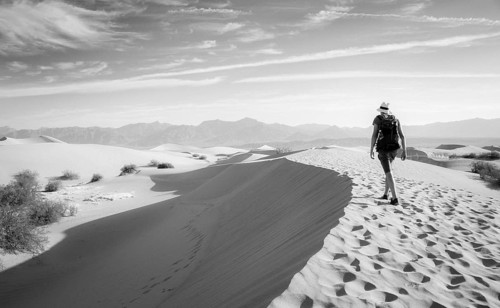 Young man hiking on sand dunes