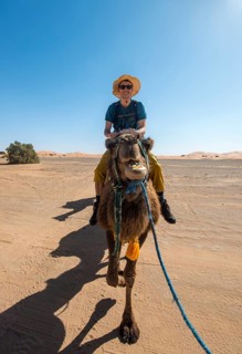 Young man riding on a camel