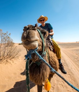 Young man riding on a camel