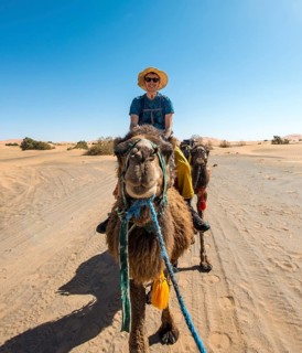 Young man riding on a camel