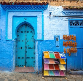 Blue entrance door with blue house facade