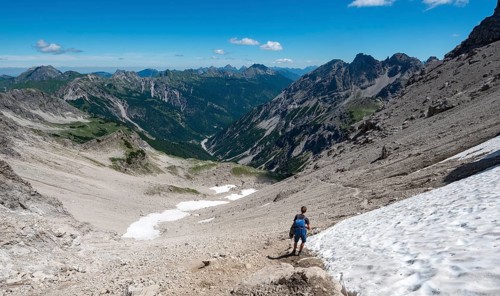 Hiker descending from Hochvogelneben Schneefeld