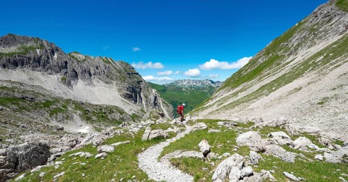 Hiker on hiking trail from Hochvogel to Prinz Luitpold Haus