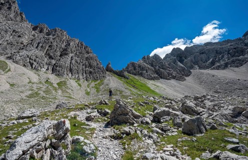 Hiker on hiking trail from Hochvogel to Prinz Luitpold Haus
