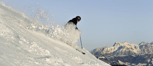 Skier with splashing snow