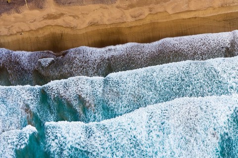 Waves running out at sandy beach