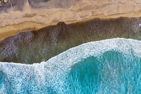 Waves running out at sandy beach