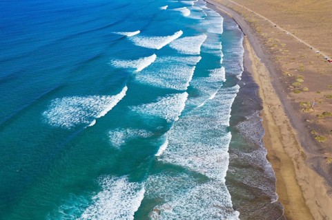 Waves running out at sandy beach