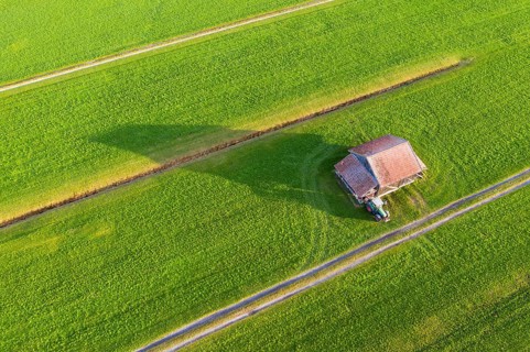 Meadows with barn and tractor