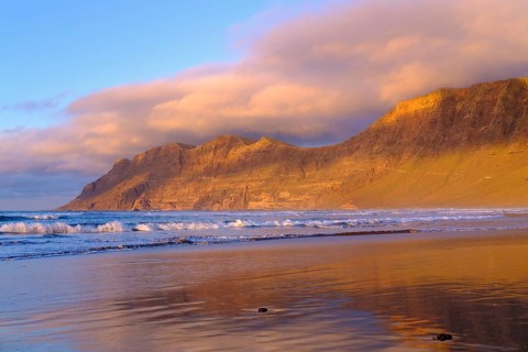 Beach at evening light with reflection