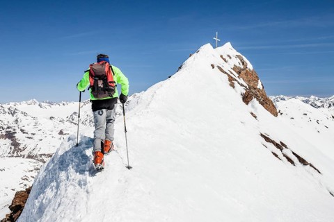 Ski tourer on ridge ascending Finailspitze in Schnals at Schnalstal Glacier