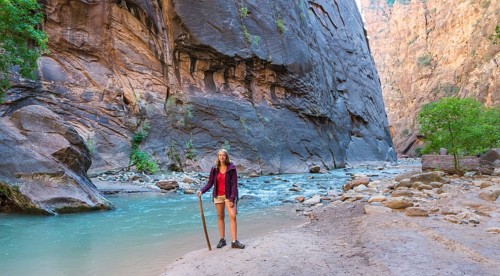 Hiker standing next to river