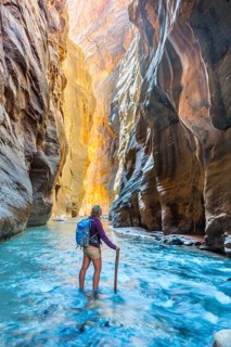 Hiker standing in river