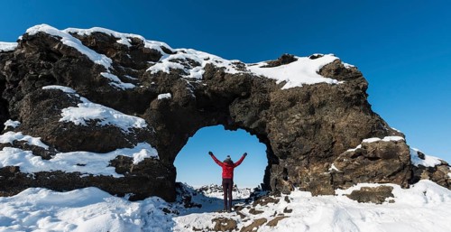Woman standing in a natural arch
