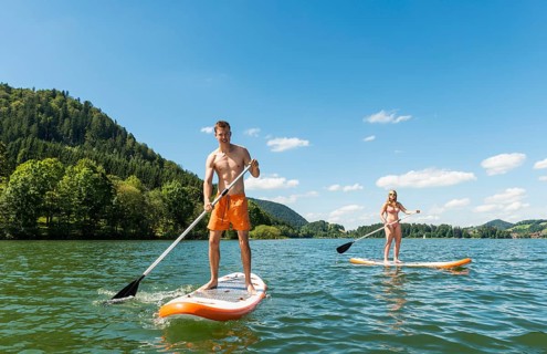Young man and woman on paddle boards