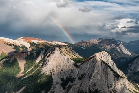 Panoramic view on mountain landscape with rainbow