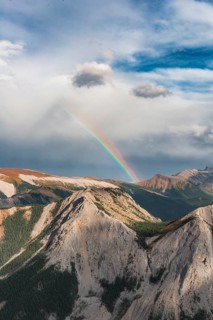 View from Sulphur Skyline Trail to mountain landscape with rainbow