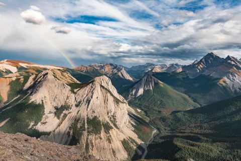 Panoramic view on mountain landscape with rainbow