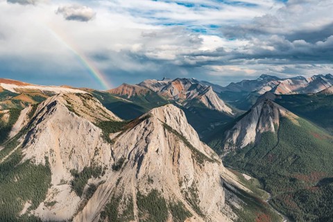 Panoramic view on mountain landscape with rainbow