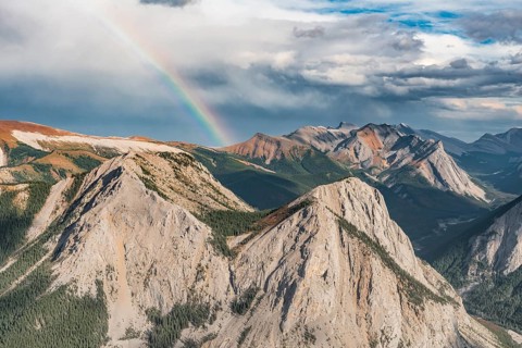 Panoramic view on mountain landscape with rainbow