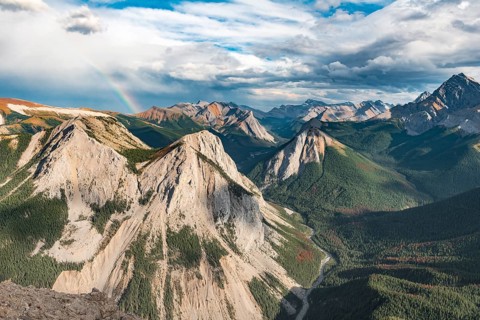 Panoramic view on mountain landscape with rainbow