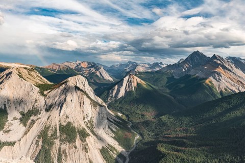 Panoramic view on mountain landscape with rainbow