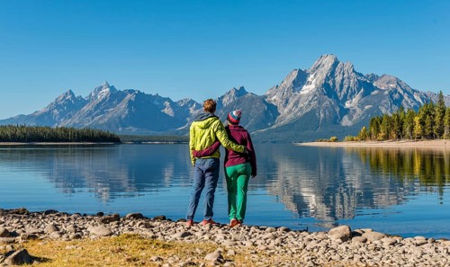 Young woman and young man standing side by side on the shore