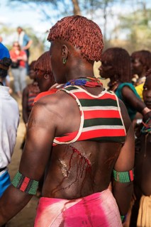 Bloody wound on the back of a woman of the Hamer tribe