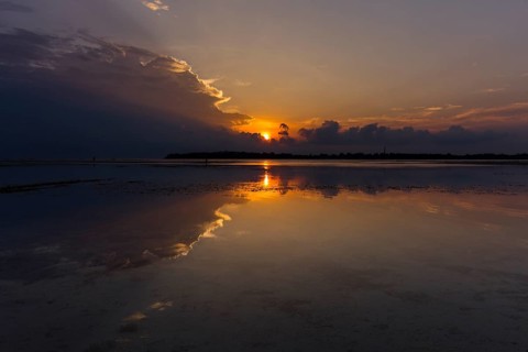 Sunset with dark clouds over the sea