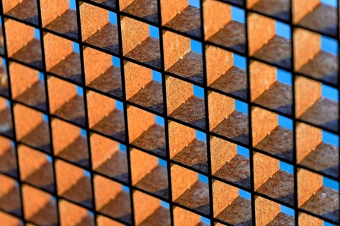 Rusty grid against a blue sky