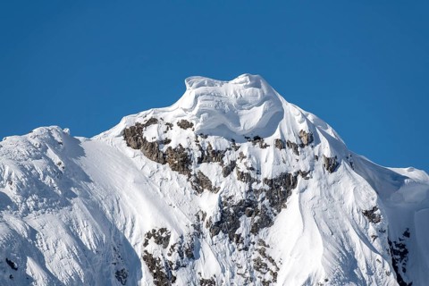 Massive snow cornice on a mountain peak