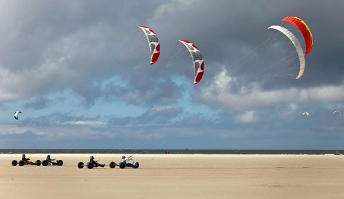 Beach sailer at the sandy beach with wind