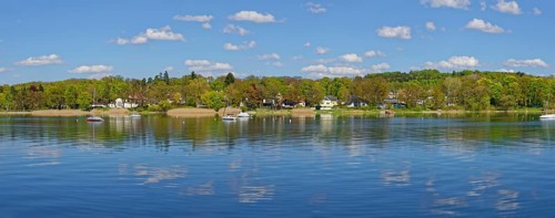Lake Ammerufer near Herrsching with water reflecting cumulus clouds