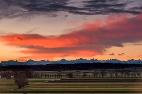 Sunrise over landscape with Alps