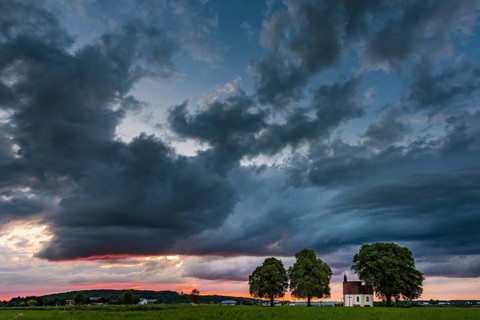 Fourteen emergency helpers chapel with dramatic cloud sky