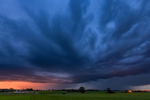 Thunderstorm sky with small village and meadows landscape