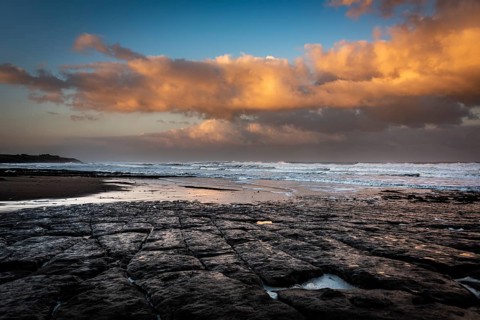 Coast with granite rocks washed by the sea in the evening light
