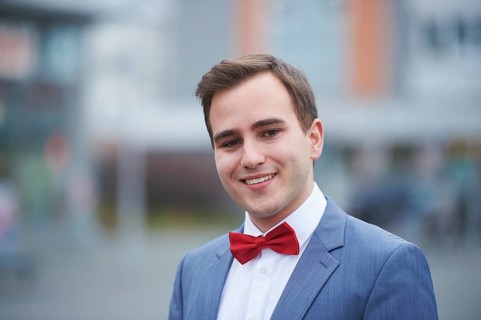 Young business man walking on street