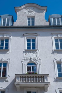 White facade with stucco and balcony